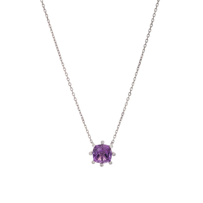 A silver-toned necklace featuring a cushion-cut purple gemstone pendant in a prong setting, flanked by small clear accent stones, shown against a plain white background. 